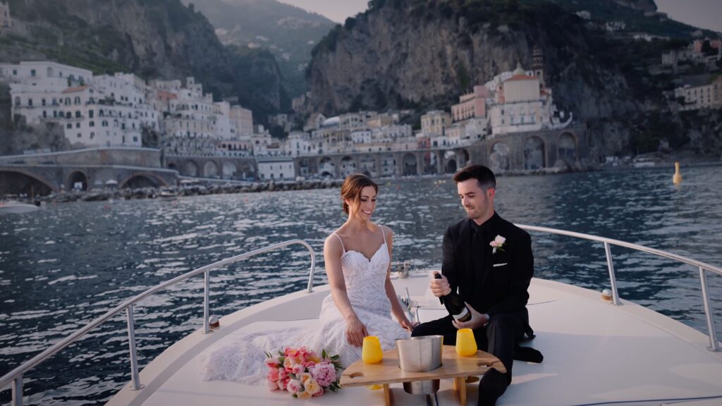 Bride and groom boat ride with Amalfi town in the background