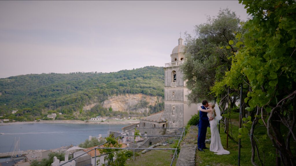 Wedding couple in Portovenere harbor with boats in the background